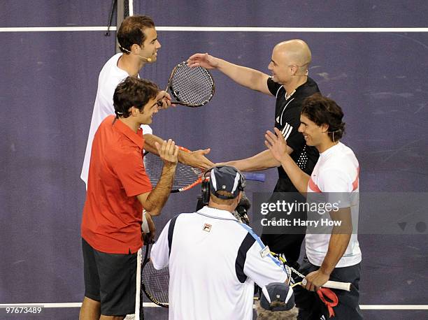 Pete Sampras of the United States and Roger Federer of Switzerland shake hands with Andre Agassi of the United States and Rafael Nadal of Spain...