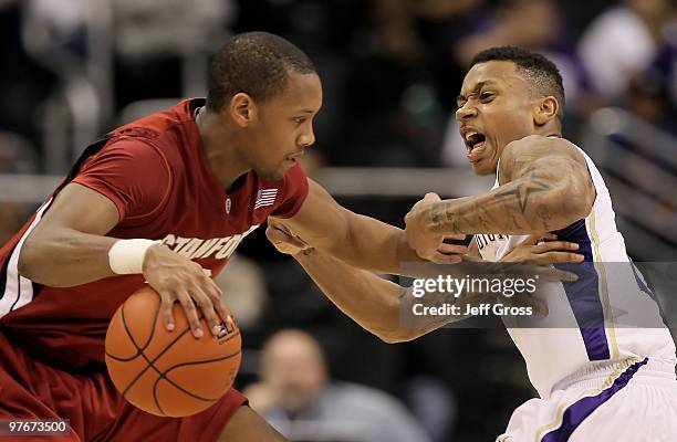 Jarrett Mann of the Stanford Cardinal is defended by Isaiah Thomas of the Washington Huskies in the first half during the Semifinals of the Pac-10...