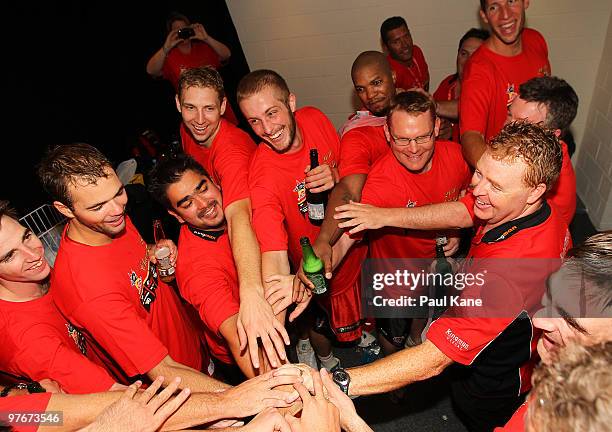 Wildcats players and coaching staff celebrate defeating the Hawks during game three of the NBL Grand Final Series between the Perth Wildcats and the...