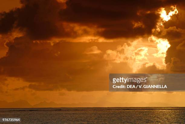 Cloudy sky over Raiatea, in the background the island of Huahine, Society Islands, French Polynesia.