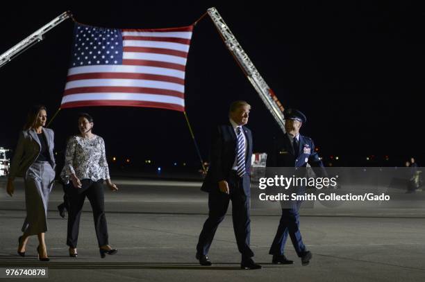 President of the United States Donald J Trump and First Lady Melania Trump walking with Col Casey D Eaton, 89th Airlift Wing commander and his wife...