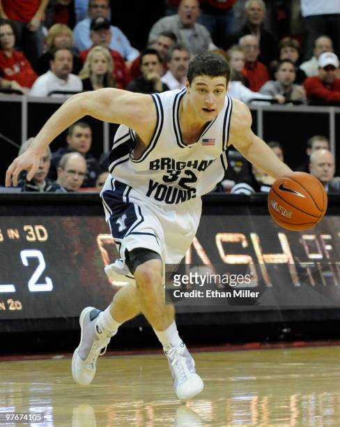 Jimmer Fredette of the Brigham Young University Cougars brings the ball up the court against the UNLV Rebels during a semifinal game of the Conoco...