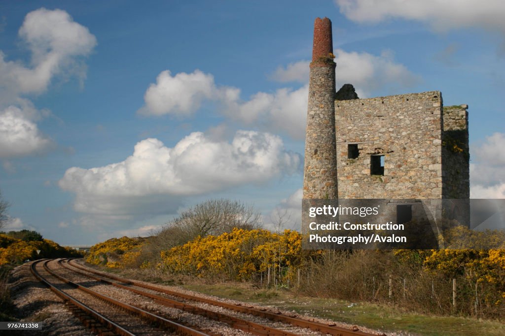 The Great Western Main Line passes the disused tin mine at Scorrier in Cornwall. April 2004