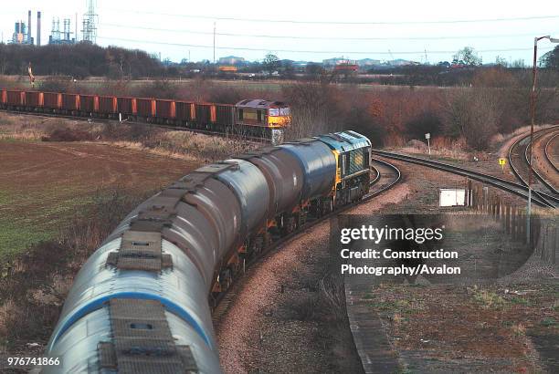 The line to Immingham Docks leaves the Doncaster - Cleethorpes passenger line at Brockleby where a Class 60 is seen leaving the dock complex with an...