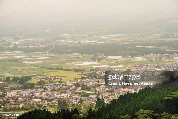 aso city with its farms and neighborhoods, view from a hilltop - kyushu stock-fotos und bilder