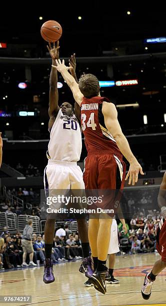 Quincy Pondexter of the Washington Huskies shoots over Andrew Zimmermann of the Stanford Cardinal during the semifinals of the Pac-10 Basketball...