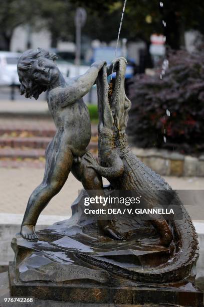 Child with crocodile, fountain in Dabrowski Square, Warsaw Old Town , Poland.