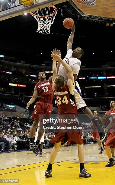 Matthew Bryan-Amaning of the Washington Huskies dunks over Andrew Zimmermann of the Stanford Cardinal during the semifinals of the Pac-10 Basketball...