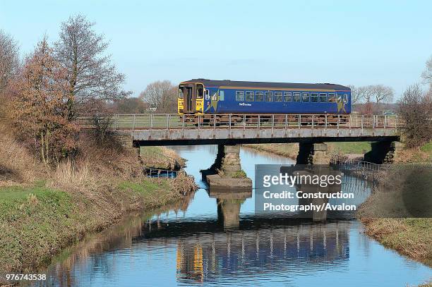 The rural scene evoked by a branch line service is well shown at Rufford as a Preston - Ormskirk service coasts across the bridge on the approach to...