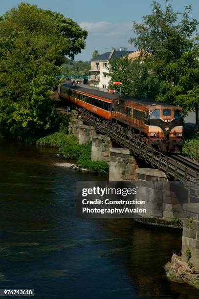 The river bridge at Enniscorthy on Tuesday 18th May 2004 with the departing 13/40 Dublin Connolly - Rosslaire train behind a CIE Class 071 Diesel...