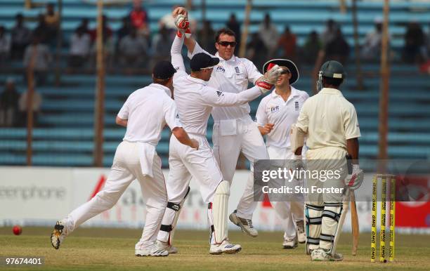 England bowler Graeme Swann celebrates with team mates after taking the wicket of Bangladesh batsman Aftab Ahmed during day two of the 1st Test...