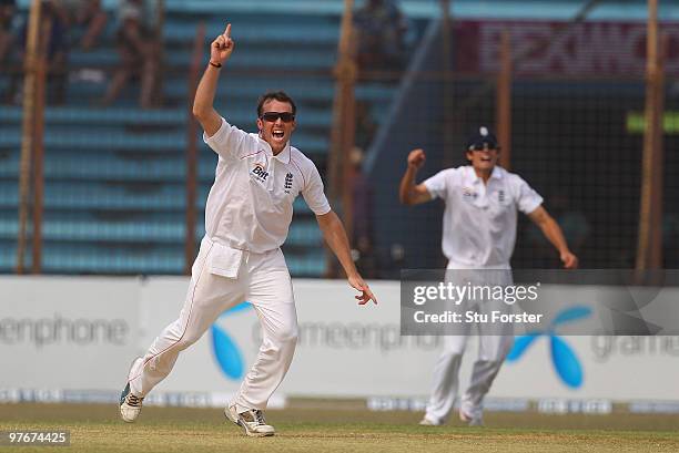 England bowler Graeme Swann celebrates with captain Alastair Cook after taking the wicket of Bangladesh batsman Aftab Ahmed during day two of the 1st...