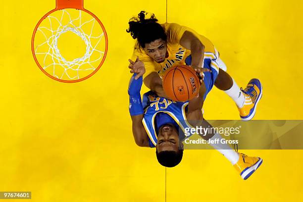 Malcolm Lee of the UCLA Bruins drives to the basket while being defended by Jorge Gutierrez of the Cal Golden Bears during the Semifinals of the...