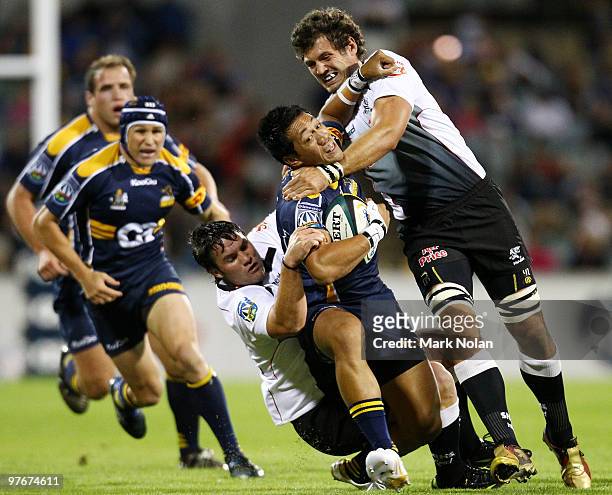 Christian Lealiifano of the Brumbies is tackled during the round five Super 14 match between the Brumbies and the Sharks at Canberra Stadium on March...