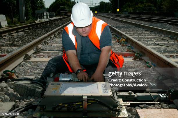 Track testing engineer attends to new points motors at Bourne End during the upgrading of the West Coast Main Line. Saturday 30th August 2003, United...