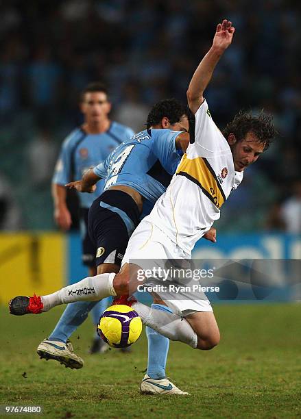 Jonathan McKain of the Phoenix is tacked by Alex Brosque of Sydney during the A-League preliminary final match between Sydney FC and the Wellington...