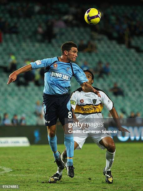 Stuart Musialik of Sydney FC heads the ball over Paul Ifill of the Phoenix during the A-League preliminary final match between Sydney FC and the...