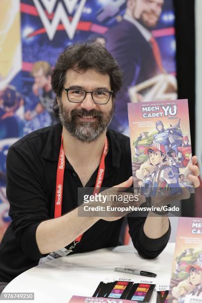 Portrait of author Greg Pak with his book Mech Cadet Yu, New York City, New York, May 31, 2018.