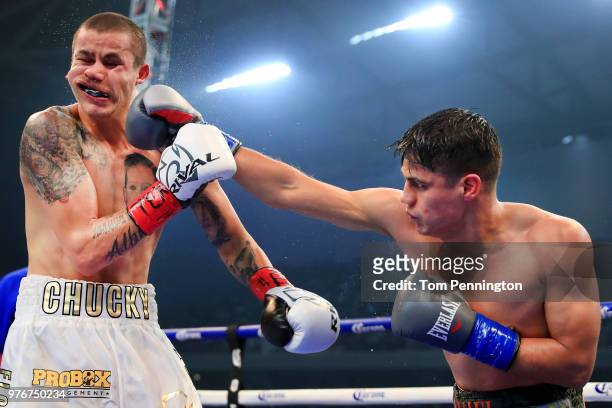 Daniel Roman lands a punch against Moises Flores in the seventh round of a WBA Super Bantamweight Championship bout at The Ford Center at The Star on...