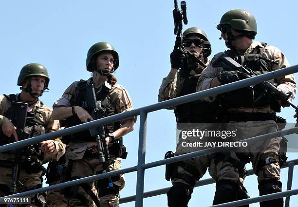 Naval personnel practice a 'visit, search and seizure' operation with their Philippine counterparts during a joint military exercise in Manila Bay on...