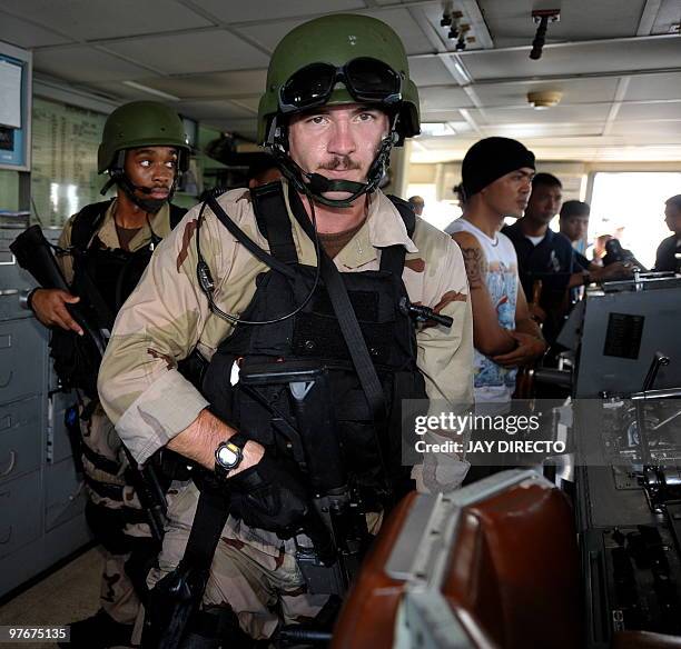 Naval personnel and their Philippine counterparts take part in a mock 'visit, search and seizure' operation during a joint military exercise in...