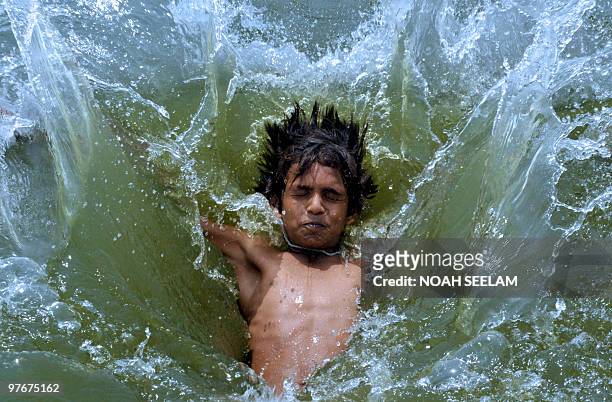 An Indian youth splashes into a river on the outskirts of Hyderabad on March 13 to beat the heat. Summer temperatures have begun to rise across India...