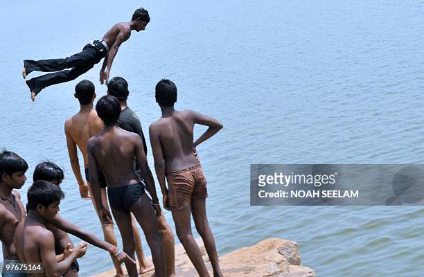 An Indian youth dives into a river on the outskirts of Hyderabad on March 13 to beat the heat. Summer temperatures have begun to rise across India...