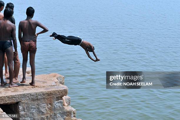 An Indian youth dives into a river on the outskirts of Hyderabad on March 13 to beat the heat. Summer temperatures have begun to rise across India...