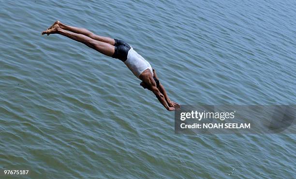 An Indian youth dives into a river on the outskirts of Hyderabad on March 13 to beat the heat. Summer temperatures have begun to rise across India...