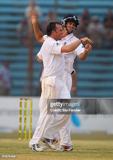 England bowler Graeme Swann celebrates with Alastair Cook after taking the wicket of Bangladesh batsman Shakib Al Hasan during day two of the 1st...