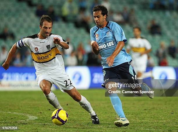 Alex Brosque of Sydney FC contests the ball with Andrew Durante of the Phoenix during the A-League preliminary final match between Sydney FC and the...