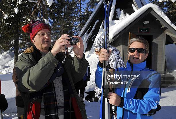 Swedish Foreign Minister Carl Bildt takes a photo as French Minister of Foreign Affairs Bernard Kouchner gets ready to ski during an informal meeting...