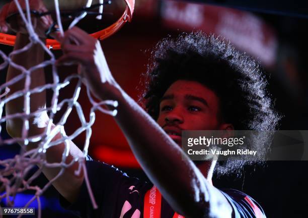 Alex White of the United States cuts the basketball net after winning Gold against Canada in the final of the FIBA U18 Americas Championship at the...