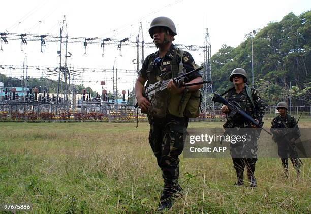Philippine soldiers patrol past an electricity substation in Nangka, Balo-i town, Lanao del Norte province in southern island of Mindanao on March...