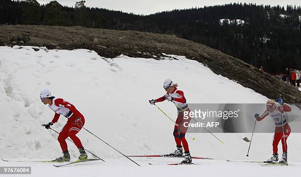 Norway's Marit Bjoergen , Kristin Stoermer and Therese Johaug skis for first, second and third place in the women's World Cup 30-kilometer...
