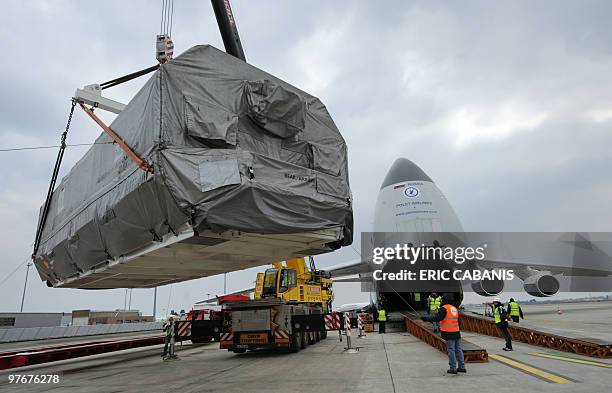 Crane lifts the Arabsat 5A satellite on March 10, 2010 to be loaded aboard a Russian Antonov 124 at Toulouse-Blagnac airport, southern France. The...