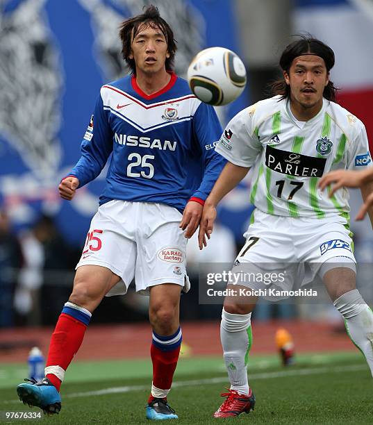 Shunsuke Nakamura of Yokohama Marinos competes for the ball with Kenji Baba of Shonan Bellmare during the J.League match between Yokohama Marinos and...