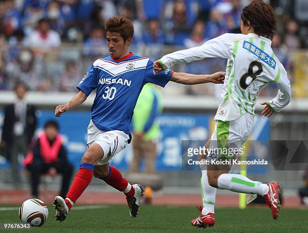Shohei Ogura of Yokohama Marinos competes for the ball with Koji Sakamoto of Shonan Bellmare during the J.League match between Yokohama Marinos and...