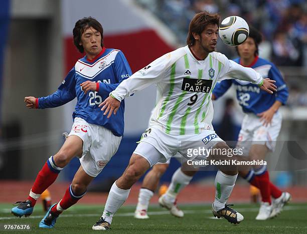 Shunsuke Nakamura of Yokohama Marinos competes for the ball with Yutaka Tahara of Shonan Bellmare during the J.League match between Yokohama Marinos...