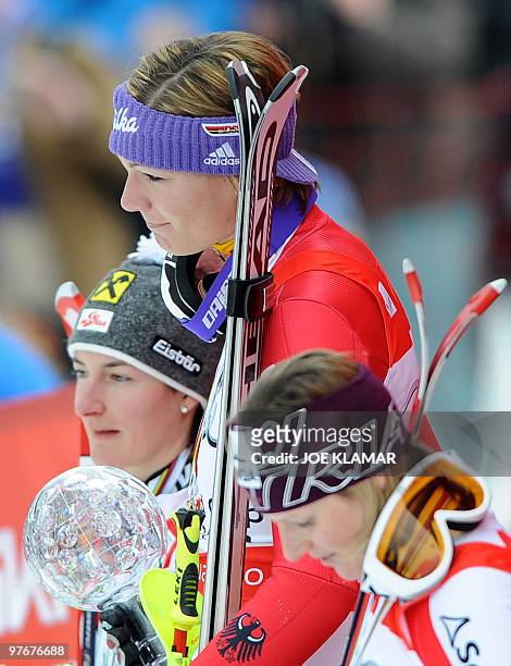 Overall slalom winners Austria's Kathrin Zettel, Germany's Maria Riesch and Austria's Marlies Schild pose in the finish area after the women's Alpine...