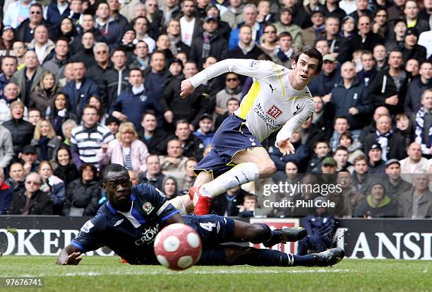 Gareth Bale of Tottenham Hotspur shoots wide under a challenge from Christopher Samba of Blackburn Rovers during the Barclays Premier League match...