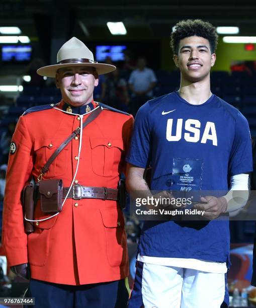 Quentin Grimes of the United States is presented his MVP of the FIBA U18 Americas Championship award by a Canadian Mountie following the United...