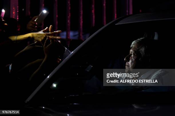 Mexican presidential candidate for the MORENA party, Andres Manuel Lopez Obrador, greets supporters from a car after a campaign rally on June 16,...