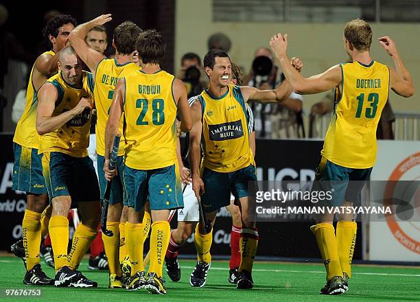 Australian hockey players celebrate after winning the World Cup 2010 Final match against Germany at the Major Dhyan Chand Stadium in New Delhi on...