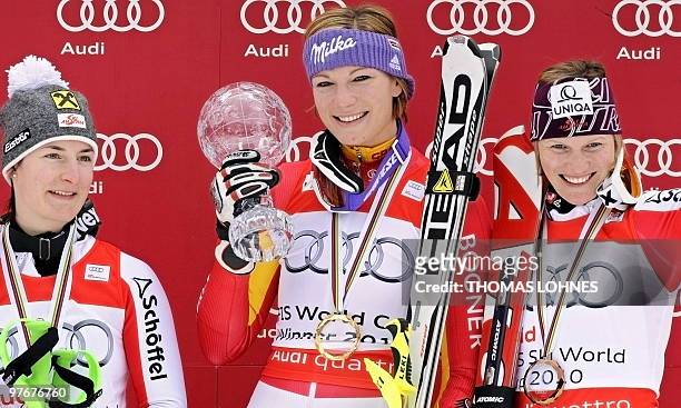 Austria's Kathrin Zettel, Germany's Maria Riesch and Austria's Marlies Schild celebrate on the podium after the women's Alpine skiing World Cup...