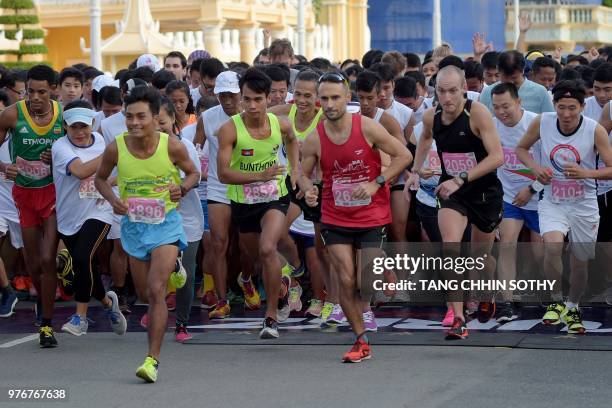 Competitors take off during the 8th Phnom Penh international half marathon participated by hundreds of people marking the birthday of former Queen...