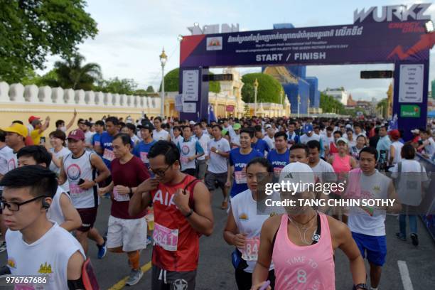 Competitors run during the 8th Phnom Penh international half marathon participated by hundreds of people marking the birthday of former Queen Norodom...