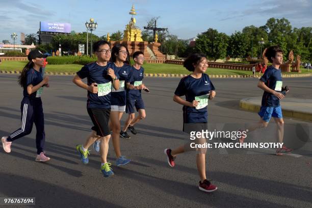 Competitors run during the 8th Phnom Penh international half marathon participated by hundreds of people marking the birthday of former Queen Norodom...