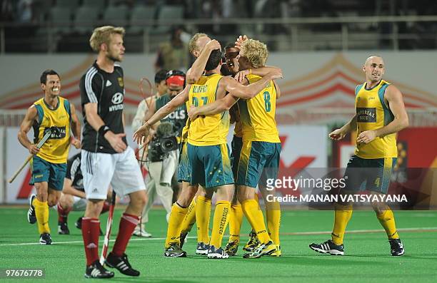 Germany hockey captain Maximilian Muller looks on as Australian hockey players celebrate after winning the World Cup 2010 Final match against Germany...