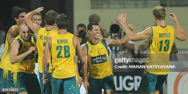 Australian hockey captain Jamie Dwyer celebrates with teammates after winning the World Cup 2010 Final match against Germany at the Major Dhyan Chand...